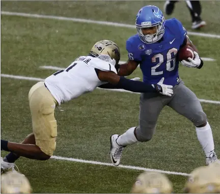  ?? JEFFREY T. BARNES — THE ASSOCIATED PRESS ?? Buffalo running back Jaret Patterson (26) is tackled by Akron’s Randy Cochran Jr. (1) during the first half of an NCAA college football game in Amherst, N.Y., Saturday.