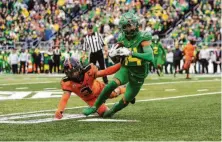  ?? Tom Hauck / Getty Images ?? Oregon’s Kris Hutson eludes Oregon State’s Jaydon Grant as the Ducks claimed a spot in next Saturday’s Pac-12 title game.