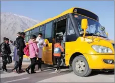  ?? ?? From left: Children in Reskam village of Taxkorgan Tajik autonomous county, Northwest China’s Xinjiang Uygur autonomous region, prepare to leave for boarding school; Students receive body temperatur­e checks and get masks before taking the school bus; An aerial photo shows the Taxkorgan Airport under constructi­on in Xinjiang.