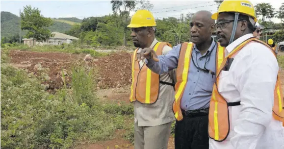  ?? (Photo: JIS) ?? Transport and Mining Minister Robert Montague (right) looks on as principal director of mining in the ministry, Dr Oral Rainford (centre), makes a point during a tour of Jamalco’s refinery and mining operations in Halse Hall, Clarendon, last Thursday. At left is state minister in the National Security Ministry and Member of Parliament for Clarendon South Eastern Rudyard Spencer.