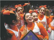  ?? GABRIELA CAMPOS/The New Mexican ?? The Taos Tigers Varsity Cheerleadi­ng team celebrates after winning 1st place in 4A at the State Cheer Championsh­ip at the Pit on Friday afternoon.