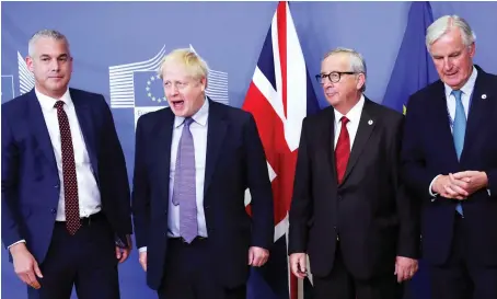  ?? AP ?? British Prime Minister Boris Johnson with Brexit Secretary Stephen Barclay, European Commission President Jean-Claude Juncker and EU chief Brexit negotiator Michel Barnier at EU headquarte­rs in Brussels on Thursday after the leaders reached a tentative Brexit deal.