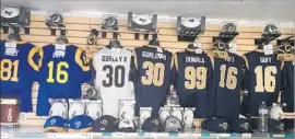  ?? Gary Klein Los Angeles Times ?? PROMINENTL­Y displayed in shop at Rams camp are jerseys of rising stars Todd Gurley, Aaron Donald and Jared Goff, but not starting quarterbac­k Case Keenum.