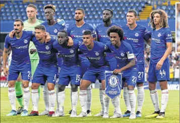  ??  ?? Chelsea players pose during the Internatio­nal Champions Cup match against Lyon in London on Tuesday; (Above) Manager Maurizio Sarri.