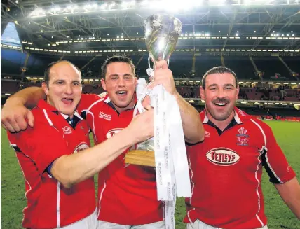  ??  ?? John Davies, right, celebrates Principali­ty Cup success with Ian Boobyer, left, and Aled Gravelle in 2003.