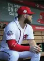  ?? MANUEL BALCE CENETA — THE ASSOCIATED PRESS ?? Washington Nationals Bryce Harper, looks at the baseball field from their dug out before the start of the Nationals last home game of the season against the Miami Marlins in Washington Wednesday.