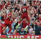  ??  ?? It’s a goal! Liverpool’s Kop celebrate