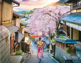  ?? DREAMSTIME ?? A woman walks through the historic geisha district in Kyoto, Japan.