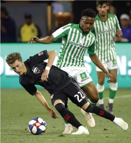  ?? Ap FiLE ?? DIFFERENT GAMES: D.C. United forward Griffin Yow (22) tries to maintain possession as he is pressured by Real Betis midfielder Wilfrid Kaptoum during the second half of a friendly match on May 22, 2019.