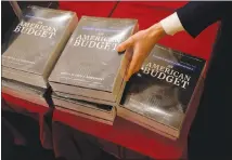  ?? ERIC THAYER / THE NEW YORK TIMES ?? Present Donald Trump’s 2019 budget proposal is delivered Monday to the House Budget Committee on Capitol Hill. The proposal calls for $4.4 trillion in spending but ignores a two-year budget deal struck last week in Congress to boost spending on...