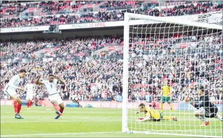  ?? GLYN KIRK/AFP ?? England striker Jermain Defoe (second left) scores the opener in the World Cup 2018 qualifier with Lithuania at Wembley Stadium in London on Sunday.