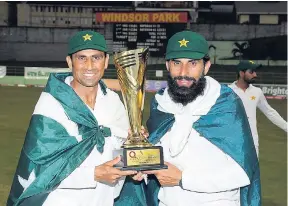  ?? PHOTO BY WICB MEDIA/RANDY BROOKS ?? Younis Khan (left) and Misbah-ul-Haq with the Q Mobile trophy after Pakistan won the third Test to clinch the three-Test series 2-1 at Windsor Park, Roseau, Dominica, on Sunday, May 14.