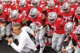  ?? DAVID JABLONSKI/STAFF ?? Ohio State coach Urban Meyer leads the Buckeyes out of the tunnel for the fifirst time this season Saturday af ter serving his three-game suspension.