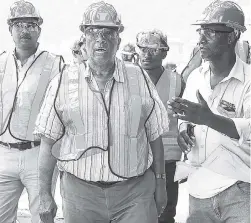  ?? CONTRIBUTE­D ?? Opposition Leader Dr Peter Phillips (centre) during at tour of the JISCO Alpart plant in St Elizabeth last Friday.