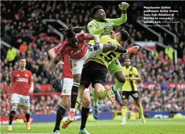  ?? Picture: Gareth Copley/Getty Images ?? Manchester United goalkeeper André Onana fouls Zeki Amdouni of Burnley to concede a penalty kick.