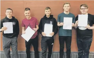  ?? ?? St Aidan’s pupils with their GCSE result papers.