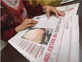  ?? PIC BY ROSELA ISMAIL ?? The mother of a bullied MRSM Alor Gajah student reading NST’s report on bullying.