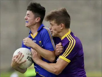  ??  ?? Wicklow’s Jack Manley feels the force of this challenge from Wexford full-back Tommy Ryan.