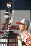  ??  ?? Denny Hamlin poses with the trophy after winning a NASCAR Cup Series auto race, on Sept. 5, in Darlington, S.C. (AP)