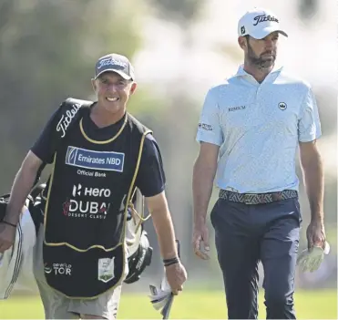  ?? ?? Scott Jamieson and his caddie Phil ‘Wobbly’ Morbey on the 18th hole at Hero Dubai Desert Classic at Emirates Golf Club yesterday and, below, Richie Ramsay en route to his 69