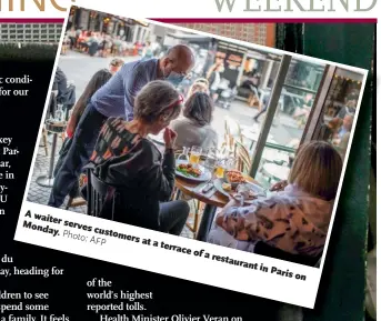  ?? Photo :AFP ?? A waiter serves customers at a terrace of restaurant in Paris on Monday.