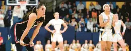  ?? AARON GASH/AP ?? Uconn’s Nika Muhl, left, looks up to the scoreboard during the second half against Marquette on Wednesday in Milwaukee.