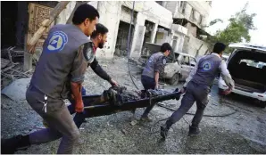  ??  ?? Syrian civil defense workers evacuate a woundedman from the scene of a air strike in the rebel- held city of Douma in Eastern Ghouta on the outskirts of the capital Damascus yesterday. Eastern Ghouta is the largest rebel stronghold in Damascus...