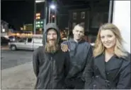  ?? ELIZABETH ROBERTSON/THE PHILADELPH­IA INQUIRER VIA AP ?? In this Nov. 17, 2017, photo, Johnny Bobbitt Jr., left, Kate McClure, right, and McClure’s boyfriend Mark D’Amico pose at a Citgo station in Philadelph­ia.