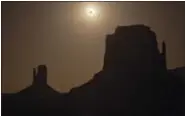  ?? JULIE JACOBSON — THE ASSOCIATED PRESS FILE ?? The new moon crosses in front of the sun creating an annular eclipse over West Mitten, left, and East Mitten buttes in Monument Valley, Ariz.
