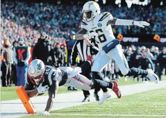  ?? ADAM GLANZMAN GETTY IMAGES ?? Sony Michel of the New England Patriots scores a touchdown against the Los Angeles Chargers on Sunday. Michel ran for 129 yards and had three touchdowns. New England now faces the Chiefs in the AFC title game.