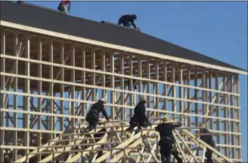  ?? PETE BANNAN - MEDIANEWS GROUP ?? Amish workers and their neighbors, rebuild a dairy barn which was destroyed in a devastatin­g fire early Wednesday morning.