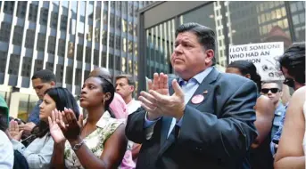  ?? TYLER PASCIAK LARIVIERE/SUN-TIMES ?? Gov. J.B. Pritzker applauds a speaker Friday at an abortion rights rally downtown.