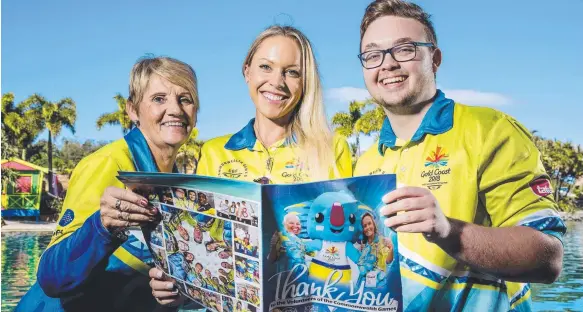  ?? Picture: JERAD WILLIAMS ?? Commonweal­th Games volunteers Julie Wallis, Petria Cumner and Daniel Lewis reading our special ‘Thank you to the volunteers’ magazine.