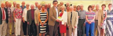  ??  ?? Ashford Rotary Club president Graeme Calver holds the special cake as members celebrate the club’s 95th anniversar­y