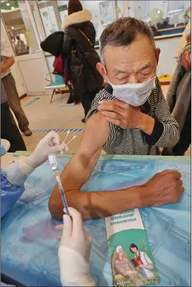  ?? ?? An elderly man gets vaccinated against covid-19 Dec. 9 at a community health center in Nantong. (AP/Chinatopix)