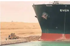  ?? FOTO: DPA ?? Ein Bagger versucht, das vordere Ende des Containers­chiffs „Ever Given“zu befreien, nachdem es im Suezkanal auf Grund gelaufen ist.