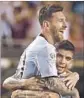  ?? Jonathan Daniel Getty Images By Kevin Baxter ?? LIONEL MESSI is lifted up by Ever Banega after scoring against Panama.