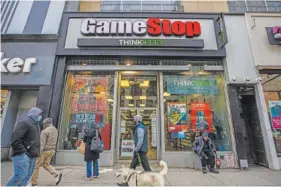  ?? HIROKO MASUIKE/THE NEW YORK TIMES ?? A GameStop store is seen Wednesday in New York. Thanks to aggressive actions of day traders on the Robinhood app, GameStop shares rocketed nearly 70% on Friday. Over the past three weeks, they’ve delivered a stupefying 1,600% gain.