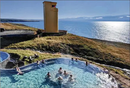  ?? 104-degree seawater pumped into a broad infinity pool with a PHOTOS BY SIMON PETER GROEBNER/MINNEAPOLI­S STAR TRIBUNE ?? Geosea Geothermal Sea Baths, in the whale-watching capital of Husavik, feature sprawling view of mountains and the Greenland Sea.