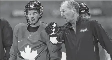  ?? AL CHAREST/CALGARY SUN ?? Team Canada coaching consultant Ralph Krueger speaks with Sidney Crosby during a practice at the 2014 Olympic Winter Games in Sochi, Russia, on Feb. 11, 2014.