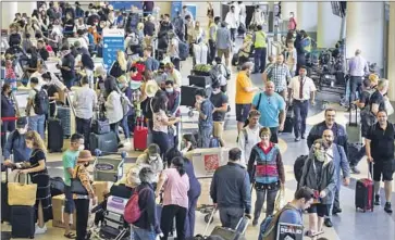  ?? Irfan Khan Los Angeles Times ?? FLIERS PACK Los Angeles Internatio­nal Airport on Friday for the July Fourth weekend. Experts with the American Automobile Assn. expect 3.3 million in Southern California­n and 48 million nationwide to travel.
