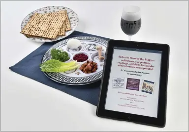  ?? JOSE CARLOS FAJARDO — STAFF PHOTOGRAPH­ER ?? A Seder plate is shown with an iPad displaying a website on how to have “Seder in Time of the Plague.” Passover begins Wednesday evening and, because of the shelter-in-place order, Jews will have to celebrate the holiday digitally.