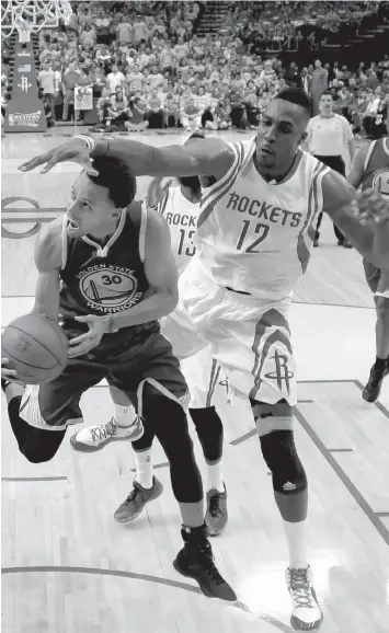  ?? ASSOCIATED PRESS ?? Golden State Warriors guard Stephen Curry eyes the basket as Houston Rockets center Dwight Howard defends during the first half in Game 3 of the Western Conference finals of the NBA basketball playoffs in Houston.