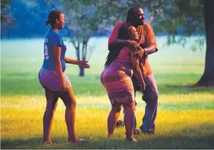  ??  ?? A man holds a woman at the scene of a Sept. 5 double shooting in Chicago’s Ogden Park. Forty people were shot in Chicago this past weekend, and the city’s death toll stands at 740 for the year so far. Erin Hooley, Chicago Tribune file