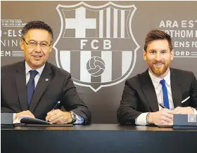  ?? GETTY IMAGES ?? Barcelona FC President Josep Bartomeu, left, announces the signing of forward Lionel Messi to a contract extension that will keep the superstar with the club until 2021.