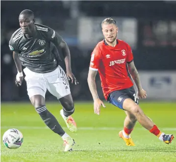  ?? REUTERS ?? Manchester United’s Eric Bailly, left, in action against Luton in the League Cup.