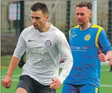  ?? Match reports and photograph­s: Derek Black. ?? Oban Saints’ James Ford is marked closely by Paul Slavin.