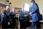  ?? [AP PHOTO] ?? Vice President Mike Pence, left, and Secret Service Director Joseph Clancy stand as President Donald Trump shakes hands with then-FBI Director James Comey in January during a reception for inaugural law enforcemen­t officers and first responders in the...