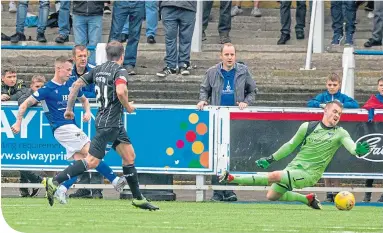  ??  ?? Gary Oliver slots home to earn Queen of the South a point