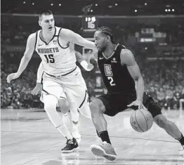  ?? HARRY HOW GETTY IMAGES ?? Nikola Jokic (15) and his Denver teammates discussed whether the Nuggets are too soft after getting crushed by Kawhi Leonard and the Clippers on Friday.